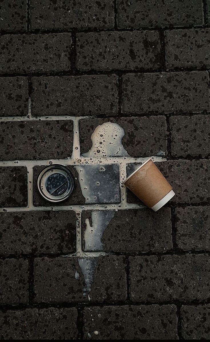 Coffee spilling on a city pavement